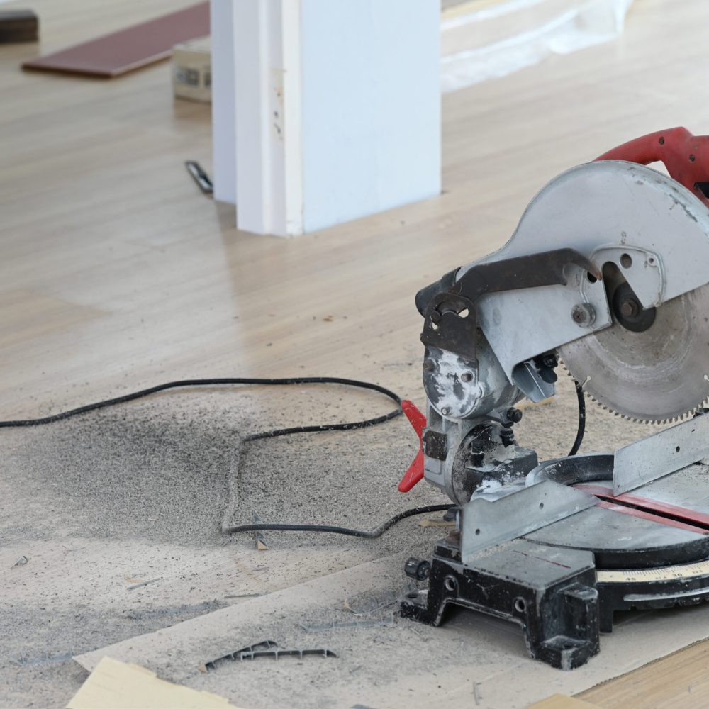 Construction carpentry tools electric corded circular saw at woodworking.